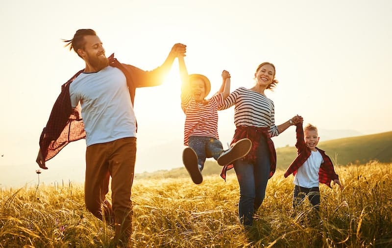 Happy family mother, father, children son and daughter on sunset
