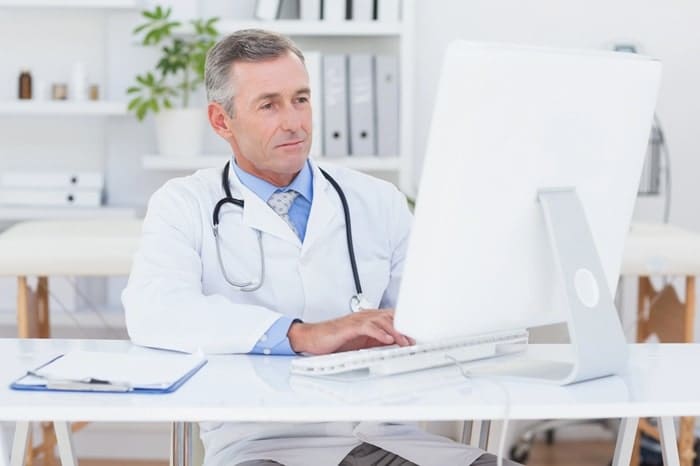 concentrating doctor using computer