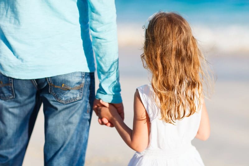 Father and daughter holding hands