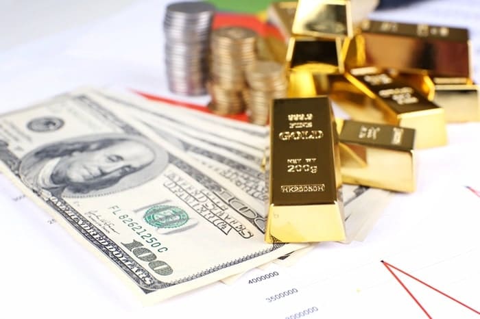 Gold bullion with money on table close up