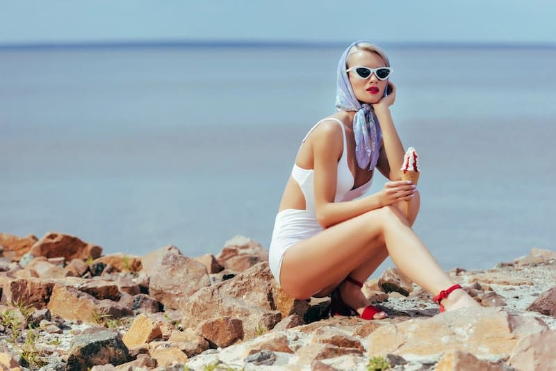 Beautiful woman in vintage swimwear holding ice cream