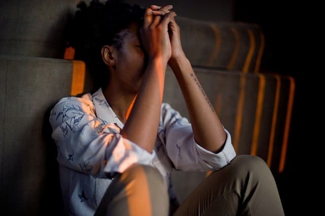 distressed woman sitting down light